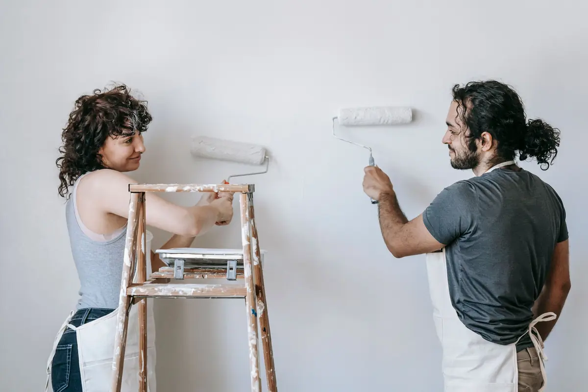 People painting a wall together — painting help in Spokane